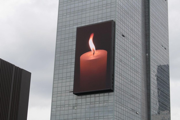 A candle burning for peace in Korean skyscrapers