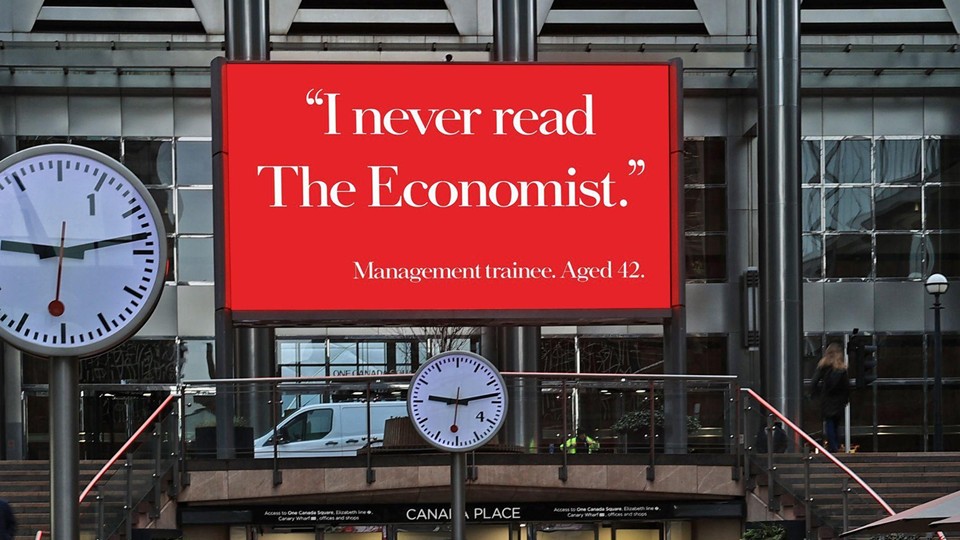 The Economist OOH poster: �I never read The Economist. Management trainee, aged 42.� in white serif type on red