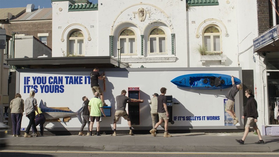 Selleys �If you can take it, it�s yours� activation: people trying to wrestle physical products glued onto a billboard