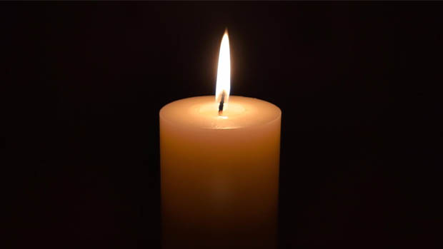 A lit candle displayed across digital out of home screens for Essays for Peace on the UN International Day of Peace